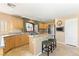 Bright kitchen features granite countertops, an island with seating, stainless appliances, and a decorative window at 10892 Royal Highlands St, Las Vegas, NV 89141