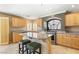 A spacious kitchen featuring an island, stainless steel appliances, and ample storage at 10892 Royal Highlands St, Las Vegas, NV 89141