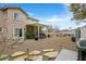 Picturesque backyard features a patio, pergola, built in grill, and ample space for activities or lounging at 1465 Via Savona Dr, Henderson, NV 89052