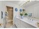 Bright bathroom featuring white cabinets, a double sink, and a shower/tub combo at 1465 Via Savona Dr, Henderson, NV 89052