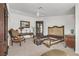 Ornate bedroom showcasing decorative furniture and a classic bed frame, bathed in natural light, ceiling fan at 1465 Via Savona Dr, Henderson, NV 89052