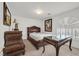 Well-lit bedroom with a dresser and desk featuring dark wood at 1465 Via Savona Dr, Henderson, NV 89052