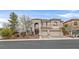 Stunning two-story home with a well manicured lawn and charming curb appeal and three-car garage at 1465 Via Savona Dr, Henderson, NV 89052