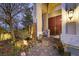 Inviting front entrance with double doors, stone accents, and a beautifully landscaped garden at 1465 Via Savona Dr, Henderson, NV 89052