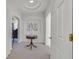 Elegant hallway with a custom niche, a decorative table, and archways leading to various rooms at 1465 Via Savona Dr, Henderson, NV 89052
