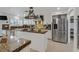 Beautiful kitchen with a stainless steel refrigerator, kitchen island, and marble counters at 1465 Via Savona Dr, Henderson, NV 89052