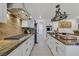 Galley kitchen featuring granite countertops, stainless steel appliances, and white cabinets at 1465 Via Savona Dr, Henderson, NV 89052