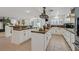 An open-concept kitchen features an island, modern appliances and custom cabinets at 1465 Via Savona Dr, Henderson, NV 89052