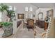 Open-concept living room with large windows, comfortable seating and elegant dining area at 1465 Via Savona Dr, Henderson, NV 89052