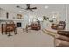 Bright living room features a fireplace, ceiling fan, and an open floor plan at 1465 Via Savona Dr, Henderson, NV 89052