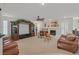 Spacious living room features built-in entertainment center, a fireplace, and plantation shutters at 1465 Via Savona Dr, Henderson, NV 89052