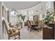 Bright living room with large windows, elegant dining set, and decorative architectural details at 1465 Via Savona Dr, Henderson, NV 89052
