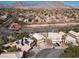 An elevated shot of houses in a neighborhood with mountain views, wide streets, and mature trees at 1501 Scenic Peak St, Las Vegas, NV 89144