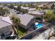 A bird's-eye view captures the property with pool, neighboring houses, and well-maintained street at 1501 Scenic Peak St, Las Vegas, NV 89144