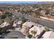 An elevated shot showcases the neighborhood with mountain views, nearby street access, and tile roofs at 1501 Scenic Peak St, Las Vegas, NV 89144