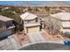 An aerial view showing the property's charming exterior, well-manicured landscaping, and desert surroundings at 1501 Scenic Peak St, Las Vegas, NV 89144