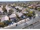 An elevated shot shows the neighborhood featuring landscaped yards, mature trees, and well-maintained roads at 1501 Scenic Peak St, Las Vegas, NV 89144