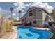Beautiful backyard oasis featuring lush landscaping, a pool, and desert landscaping at 1501 Scenic Peak St, Las Vegas, NV 89144