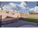 Beautiful backyard with lush synthetic grass, stone seating area and butterfly accents at 1501 Scenic Peak St, Las Vegas, NV 89144