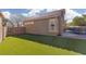 This landscaped backyard features synthetic lawn, fencing, mature trees and a sparkling blue pool at 1501 Scenic Peak St, Las Vegas, NV 89144