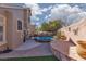 Relax in this backyard featuring a pool, spa, stone patio, and well-manicured landscaping at 1501 Scenic Peak St, Las Vegas, NV 89144