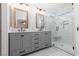 Elegant bathroom features a double vanity with stone countertop and a sleek glass-enclosed shower at 1501 Scenic Peak St, Las Vegas, NV 89144