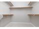 Walk-in closet with neutral carpet, white walls, and wooden railings offering ample storage space at 1501 Scenic Peak St, Las Vegas, NV 89144