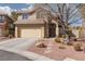 Inviting two-story home featuring desert landscaping, a two-car garage and neutral color palette at 1501 Scenic Peak St, Las Vegas, NV 89144