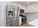 Bright kitchen features stainless appliances, white cabinets, and modern finishes at 1501 Scenic Peak St, Las Vegas, NV 89144