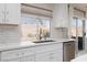 Updated kitchen featuring white cabinets, countertops, and stainless appliances at 1501 Scenic Peak St, Las Vegas, NV 89144