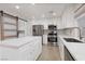 Updated kitchen features white cabinets, quartz countertops, and stainless appliances at 1501 Scenic Peak St, Las Vegas, NV 89144