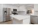 Updated kitchen with stainless appliances, tile backsplash, and quartz counters at 1501 Scenic Peak St, Las Vegas, NV 89144