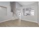 Open concept living area with neutral walls, luxury vinyl flooring and staircase leading to upper level at 1501 Scenic Peak St, Las Vegas, NV 89144