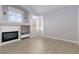 Living area featuring luxury vinyl flooring, fireplace with white surround, and well-lit windows at 1501 Scenic Peak St, Las Vegas, NV 89144