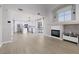 Open-concept living space with modern white kitchen, stainless appliances, fireplace and luxury vinyl floors at 1501 Scenic Peak St, Las Vegas, NV 89144