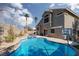 Beautiful backyard pool with spa, patio area, and privacy wall, perfect for outdoor enjoyment at 1501 Scenic Peak St, Las Vegas, NV 89144