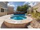 Backyard with in-ground pool and hot tub, privacy wall and desert landscaping at 1501 Scenic Peak St, Las Vegas, NV 89144