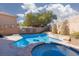 Backyard pool and hot tub with patio, safety fence and privacy wall at 1501 Scenic Peak St, Las Vegas, NV 89144