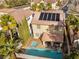 Aerial perspective showcases the property's pool, spa, and solar panels amidst a residential neighborhood at 1661 Warrenville St, Las Vegas, NV 89117