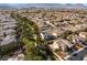 An aerial view highlights a home with solar panels in a neighborhood graced with lush, mature trees and community green spaces at 1661 Warrenville St, Las Vegas, NV 89117