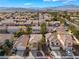 This aerial photo showcases the home's facade, roof, attached garage, and neatly manicured front yard at 1661 Warrenville St, Las Vegas, NV 89117
