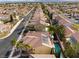 Suburban neighborhood featuring a home with solar panels, a private pool, and well-maintained yards at 1661 Warrenville St, Las Vegas, NV 89117