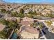 A beautiful aerial view of the property showcasing a pool, solar panels, and lush landscaping at 1661 Warrenville St, Las Vegas, NV 89117