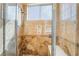 Bathroom features a tiled walk-in shower with a bench seat and tiled window at 1661 Warrenville St, Las Vegas, NV 89117