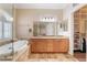 Bathroom features granite counters, a tiled floor, a soaking tub, and a walk-in shower at 1661 Warrenville St, Las Vegas, NV 89117