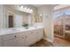 Bathroom featuring double sinks and a separate glass shower with tiled surround at 1661 Warrenville St, Las Vegas, NV 89117