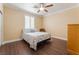 Bedroom featuring warm neutral colors, wood-look flooring, bright natural light, and a ceiling fan at 1661 Warrenville St, Las Vegas, NV 89117