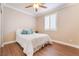 Bedroom featuring warm neutral colors, wood-look flooring, bright natural light, and a ceiling fan at 1661 Warrenville St, Las Vegas, NV 89117