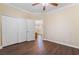 Bedroom features a ceiling fan, wood floors, and a closet at 1661 Warrenville St, Las Vegas, NV 89117