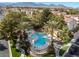 Discover the community pool surrounded by lush greenery, offering a serene and relaxing recreational space at 1661 Warrenville St, Las Vegas, NV 89117